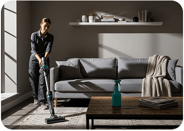 Professional cleaner vacuuming with attention to detail